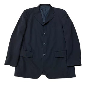 May include: A dark navy blazer with a four-button closure, two front pockets, and a notched lapel. The jacket has a classic, tailored design, suitable for formal or business attire. The blazer is a solid color and appears to be made of a smooth fabric.