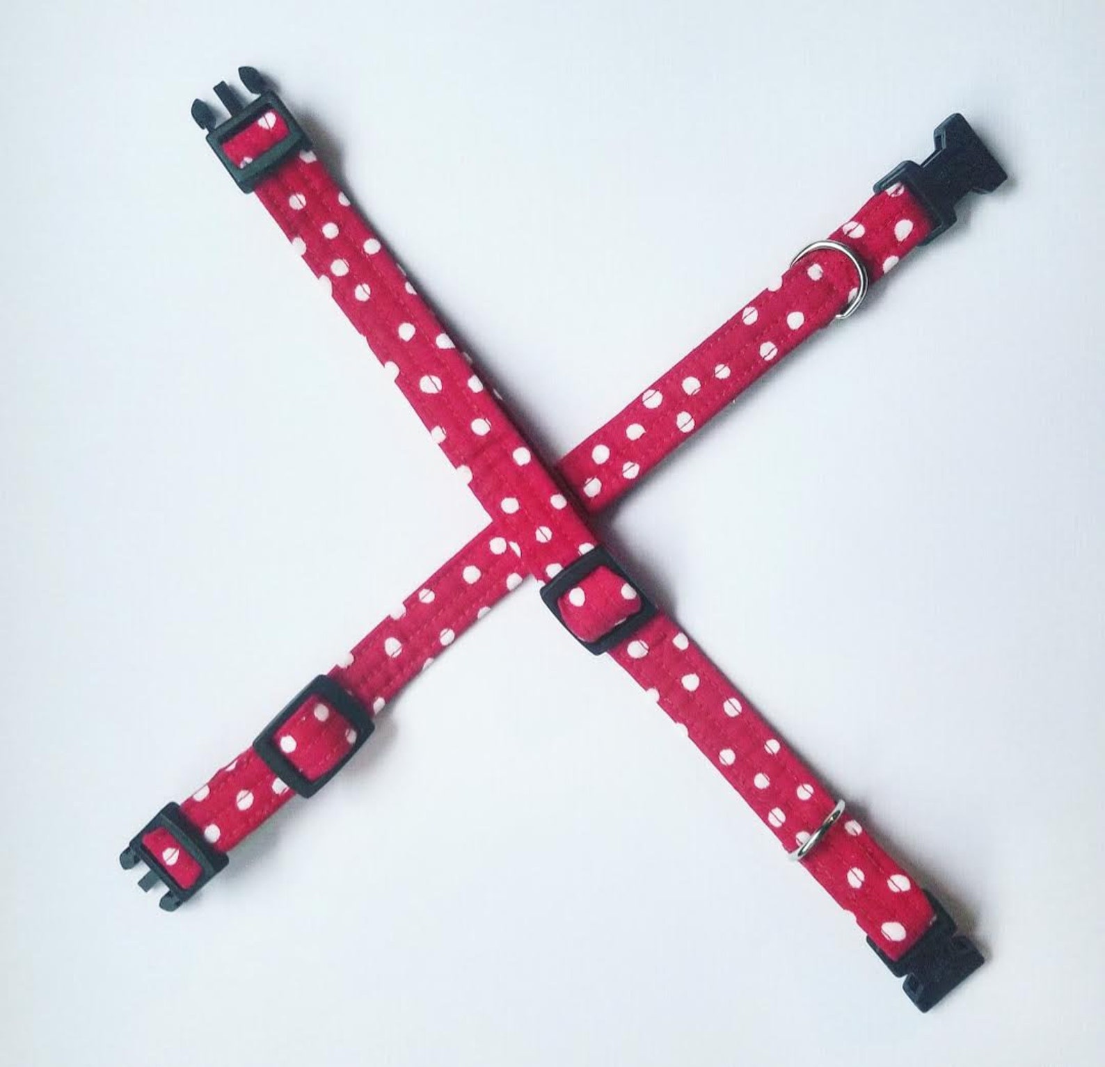 Red and white polka dot dog 
plush with green scarf