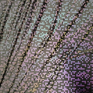 May include: Black fabric with a subtle iridescent pattern of small squares in shades of pink, blue, and yellow.