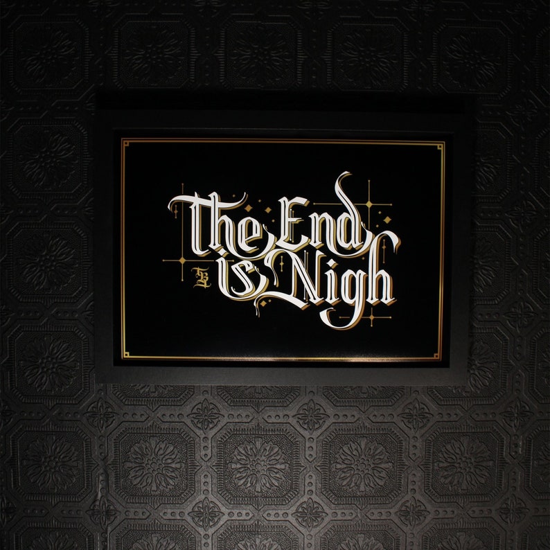 May include: A black framed sign with gold accents and the text "The End is Nigh" in white cursive lettering.