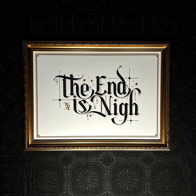 May include: A gold framed picture with a white background and black calligraphy that reads "The End is Nigh".