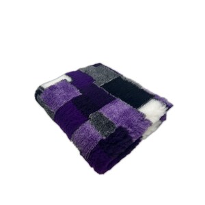 May include: Purple, black, gray, and white checkered plush throw blanket. The blanket is folded in half and the checkered pattern is visible on both sides.