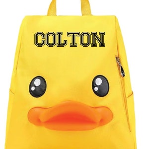 May include: Yellow duck backpack with a black name tag that says "COLTON".