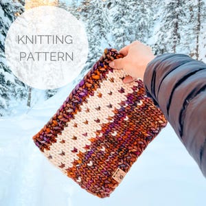 May include: A hand-knitted cowl in shades of brown, cream, purple, and orange. The cowl features a geometric pattern and a small leather tag. The text "KNITTING PATTERN" is in a white circle in the background.