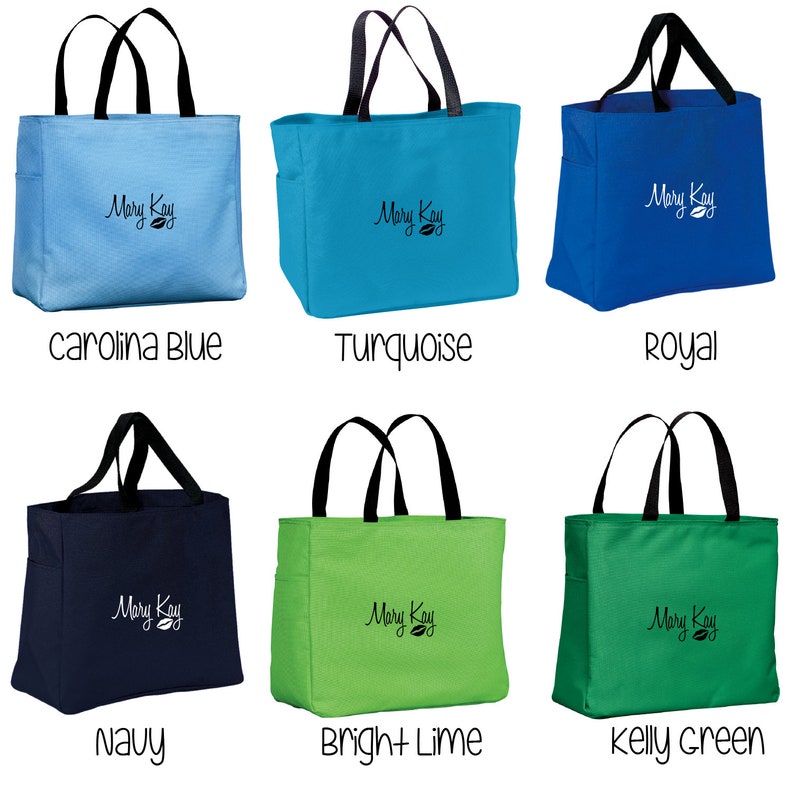 May include: Six tote bags in different colors, including turquoise, royal blue, kelly green, navy, bright lime, and carolina blue. Each bag has black handles and a white "Mary Kay" logo with a leaf design.