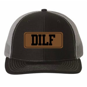 May include: A black and gray trucker hat with a brown leather patch that says "DILF" in black letters.