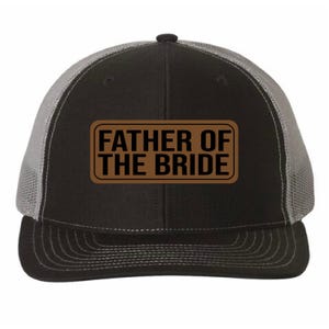 May include: Black and gray trucker hat with a brown leather patch that says "Father of the Bride" in black text.