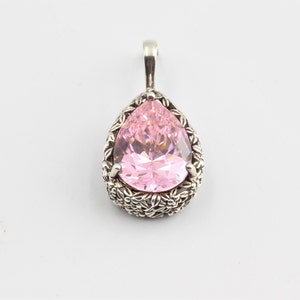 Beautiful dazzling pink pear-shaped cubic zirconia bezel set with prongs in a floral design open work silver pendant