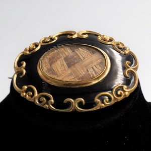 Antique Victorian Pinchbeck and black enamel mourning brooch with two tone woven hair