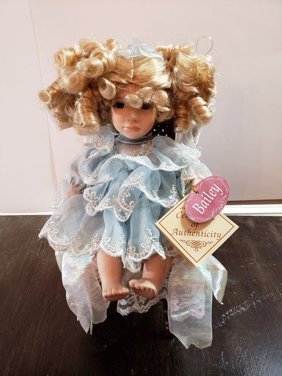 Vintage Certified Bailey bisque porcelain handcrafted doll in a windup music playing chair