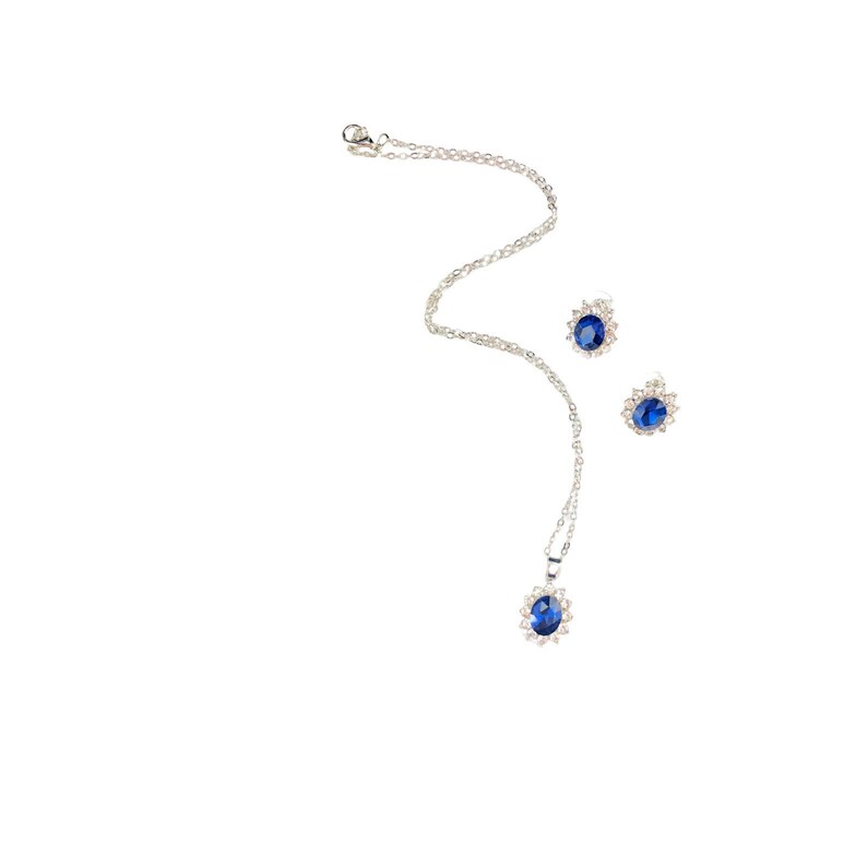 May include: A silver necklace and earrings set with a blue oval gemstone surrounded by smaller clear stones.