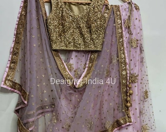 May include: A pink and gold Indian bridal outfit with a sequined bodice, a sheer skirt, and a matching dupatta. The outfit is decorated with intricate embroidery and embellishments.