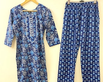 May include: A blue and white floral print cotton kurta and pajama set. The kurta has a round neckline and three-quarter sleeves. The pajama has an elastic waistband.