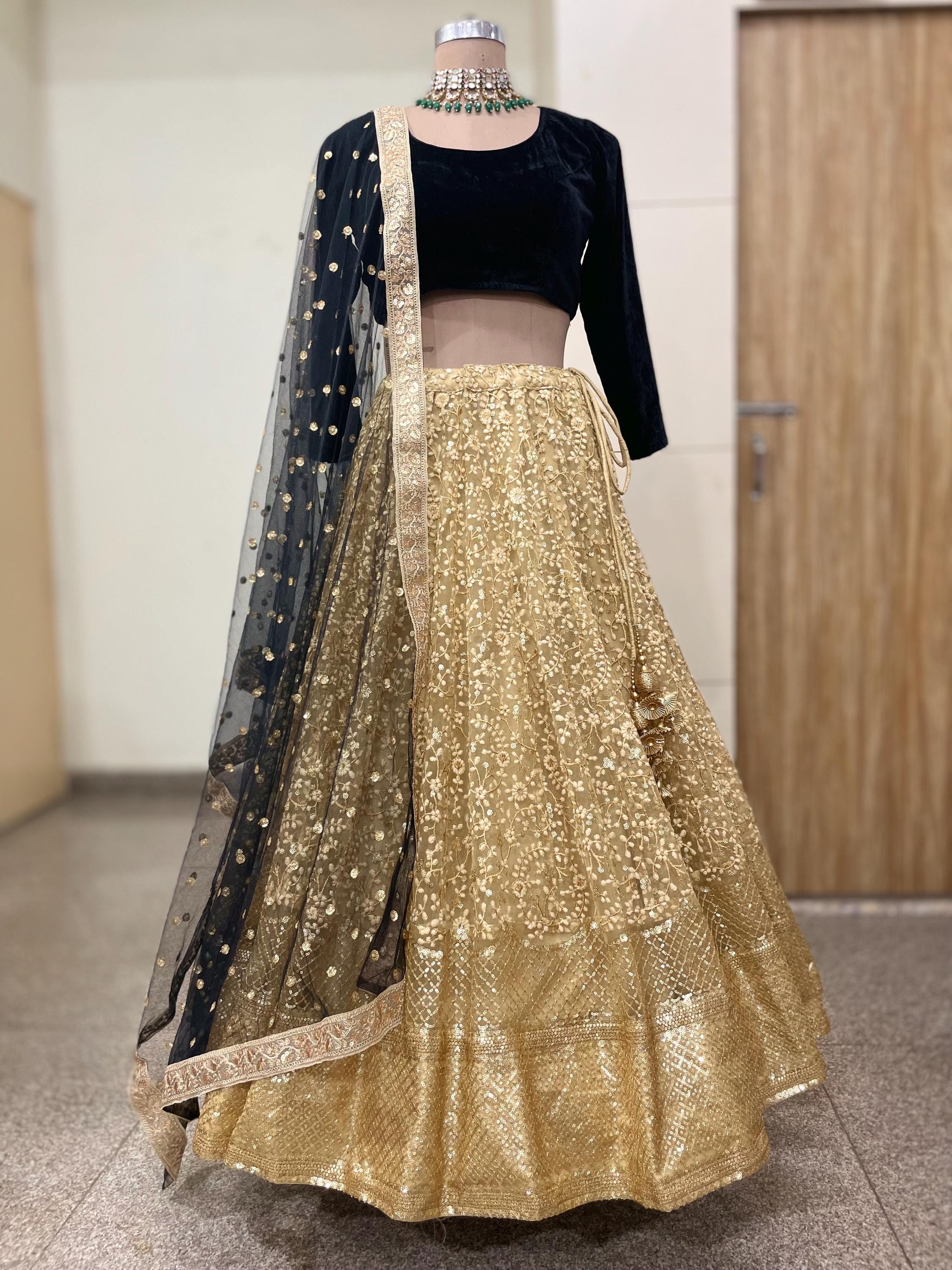 Gold lehenga with black long sleeve blouse embroidered dupatta