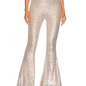 May include: Silver sequined flared pants with a high waist.