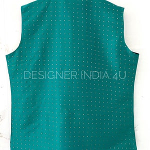 May include: A teal sleeveless vest with a small, white dot pattern. The vest has a mandarin collar and a button closure. The text "DESIGNER INDIA 4U" is printed on the back of the vest.