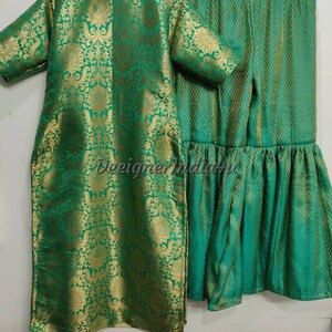 May include: A two-piece green and gold brocade outfit. The top is a long tunic with short sleeves. The matching pants have a flared hem. The fabric has a floral pattern. The text "DeeignerIndia4u" is visible.