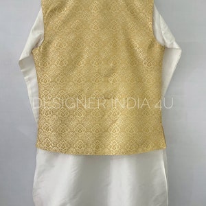 May include: A white kurta with a gold brocade waistcoat. The waistcoat has a traditional Indian design.