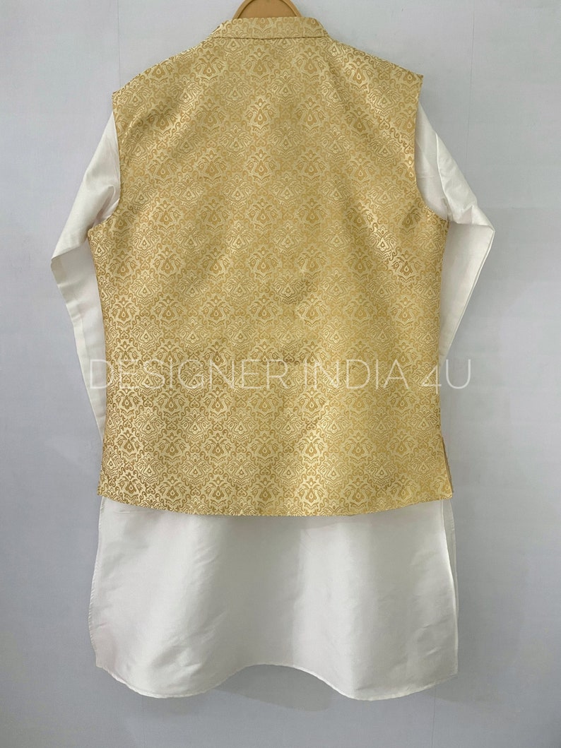 May include: A white kurta with a gold brocade waistcoat. The waistcoat has a traditional Indian design.