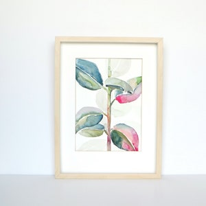 May include: A framed watercolour painting of a plant with green and pink leaves. The leaves are painted in a realistic style, with subtle variations in colour and texture. The painting is set against a white background.