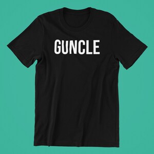 May include: Black t-shirt with the word "GUNCLE" printed in white on the front.