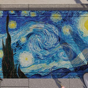 May include: A blue and yellow doormat with a swirling pattern reminiscent of Vincent van Gogh's "Starry Night" painting.