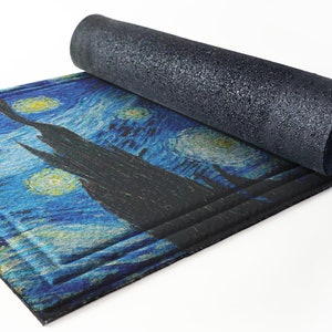 May include: A rolled-up doormat with a blue and yellow starry night design. The doormat has a black backing.