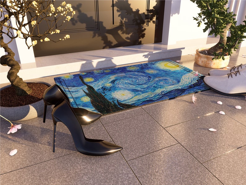 May include: A blue and yellow doormat with a swirling pattern reminiscent of Van Gogh's Starry Night. Two black high-heeled shoes are on the doormat, and a white shoe is on the floor.