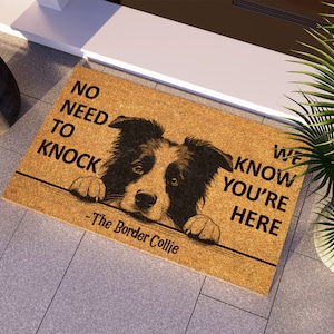 May include: A brown coir doormat with the text "No need to knock, we know you're here - The Border Collie" and a black and white border collie dog peeking over the top.
