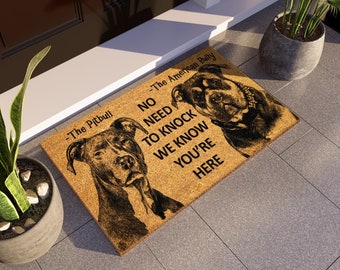 May include: A brown doormat with the text "No need to knock we know you're here" and two dog silhouettes. The text "The Pitbull" is above the silhouette of a Pitbull dog and the text "The American Bully" is above the silhouette of an American Bully dog.