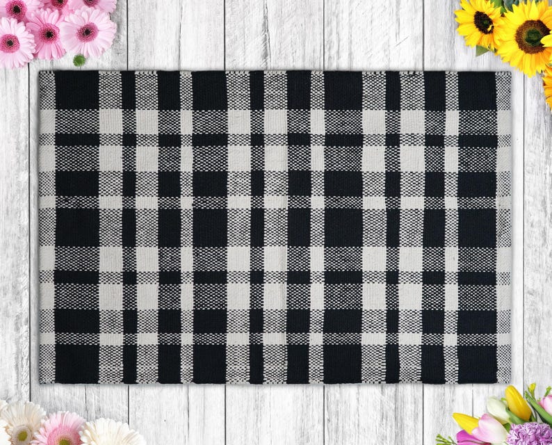 a black and white checkered rug next to flowers