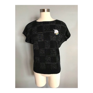 Black sweater with unicorn patch