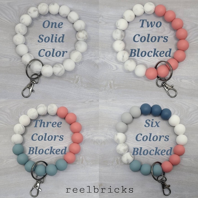 May include: Four silicone beaded keychains in different color combinations. The first keychain is all white with a marble pattern. The second keychain is white with marble pattern and pink. The third keychain is white with marble pattern, pink, and blue. The fourth keychain is gray, blue, and pink. All keychains have a silver key ring.