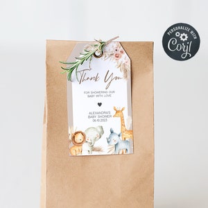 May include: A brown paper gift bag with a white tag attached. The tag has a thank you message, a giraffe, a lion, a rhino, and the text "Alexandra's Baby Shower 06.10.2023".