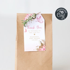 May include: A brown paper bag with a pink and gold thank you tag attached. The tag features a butterfly, flowers, and the text "Thank You for showering our baby with love, Maddison's Baby Shower 1.20.2039".