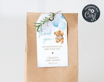 May include: A brown paper gift bag with a blue and white thank you tag. The tag features a teddy bear holding balloons and the text "Thank you for showering our baby with love." The tag also includes the date "09.23.23" and the text "Caroline's Baby Shower".