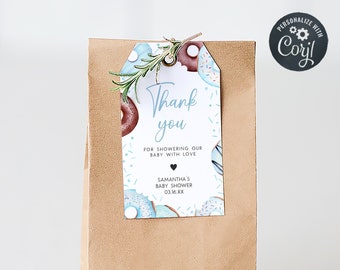 May include: A brown paper bag with a blue and white donut-themed thank you tag attached. The tag says "Thank you for showering our baby with love, Samantha's Baby Shower 03.16 XX".