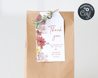 May include: A brown paper gift bag with a floral thank you tag attached. The tag says "Thank you" and "For showering our baby with love." It also includes the text "Cassandra's Baby Shower 03.16.XX".