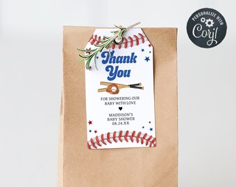 May include: A brown paper gift bag with a baseball-themed tag. The tag reads "Thank You" in blue script, with baseball bats and a ball graphic. The tag is decorated with red stitching and stars, and includes the text "For showering our baby with love."