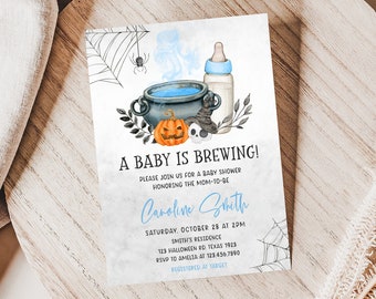 May include: A baby shower invitation with a Halloween theme. The invitation features a cauldron, pumpkin, skull, and baby bottle illustration. Text reads "A Baby is Brewing!" and includes event details.