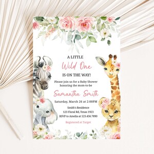 May include: A baby shower invitation with a pink floral border and illustrations of a zebra, giraffe, elephant, and lion. The text reads "A Little Wild One Is On The Way!" and includes the name "Samantha Smith", the date and time of the shower, the location, and RSVP information.