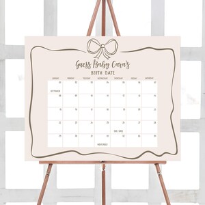 a calendar on a easel with a bow on it