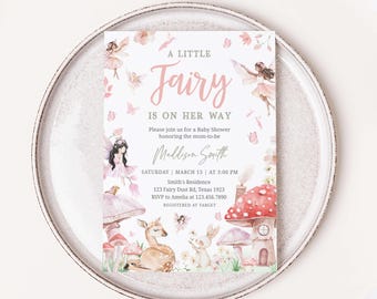 May include: A baby shower invitation with a pink and green fairy theme. The invitation features a watercolor illustration of a fairy, mushrooms, and a deer. The text on the invitation reads "A Little Fairy Is On Her Way".