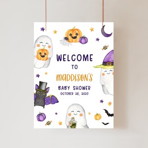 May include: A Halloween-themed baby shower sign with watercolor illustrations. The sign features ghosts, pumpkins, bats, and stars. Text reads "Welcome to Maddison's Baby Shower October 28, 2023."