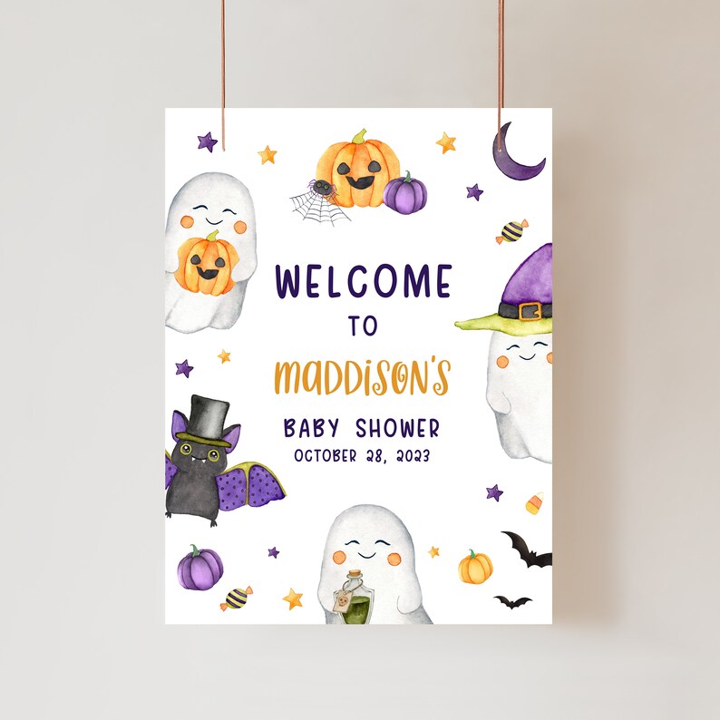 May include: A Halloween-themed baby shower sign with watercolor illustrations. The sign features ghosts, pumpkins, bats, and stars. Text reads "Welcome to Maddison's Baby Shower October 28, 2023."