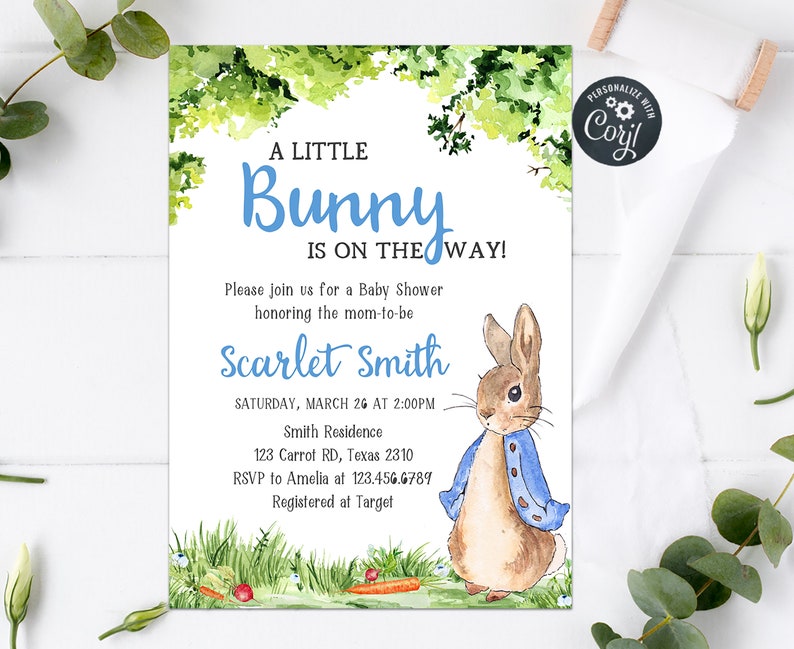 May include: A baby shower invitation with a watercolor illustration of a bunny rabbit wearing a blue jacket. The invitation says "A Little Bunny Is On The Way!" and includes the date, time, and location of the shower.
