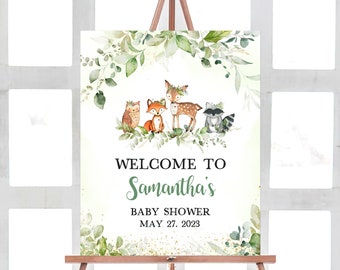May include: Welcome to Samantha's Baby Shower sign with a green leafy border and woodland animals including a deer, fox, owl, and raccoon. The date of the shower is May 27, 2023.