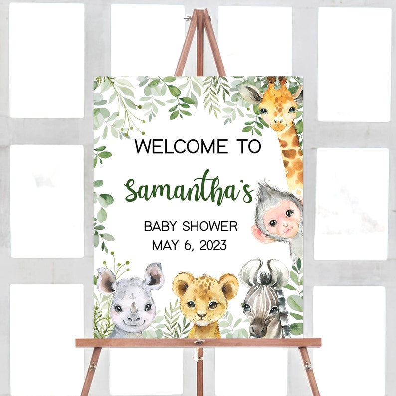 May include: Welcome to Samantha's Baby Shower on May 6, 2023. A white sign with green foliage border features a giraffe, monkey, lion, zebra, and rhinoceros.