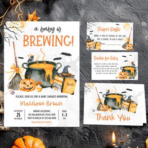 A Halloween-themed baby shower invitation featuring a pot of bubbling soup, pumpkins, bats, and a broomstick, along with a list of details for the baby shower.