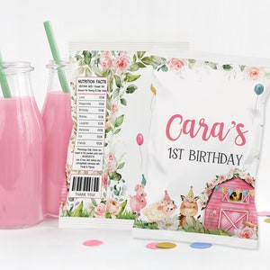 May include: White favor bag with a pink barn, farm animals, and flowers. The bag has the text "Cara's 1st Birthday" printed on it.